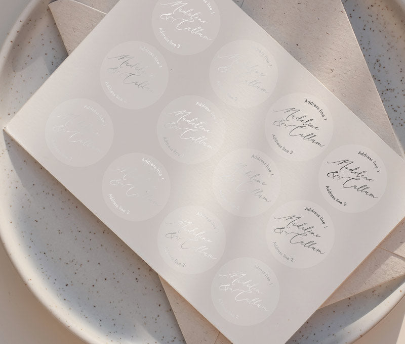 Return address sticker sheet printed in silver on clear round sticker with names in calligraphy font