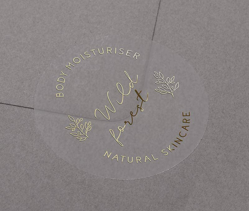 Personalised text for business name and custom text curved on top and bottom of round clear sticker printed in gold foil