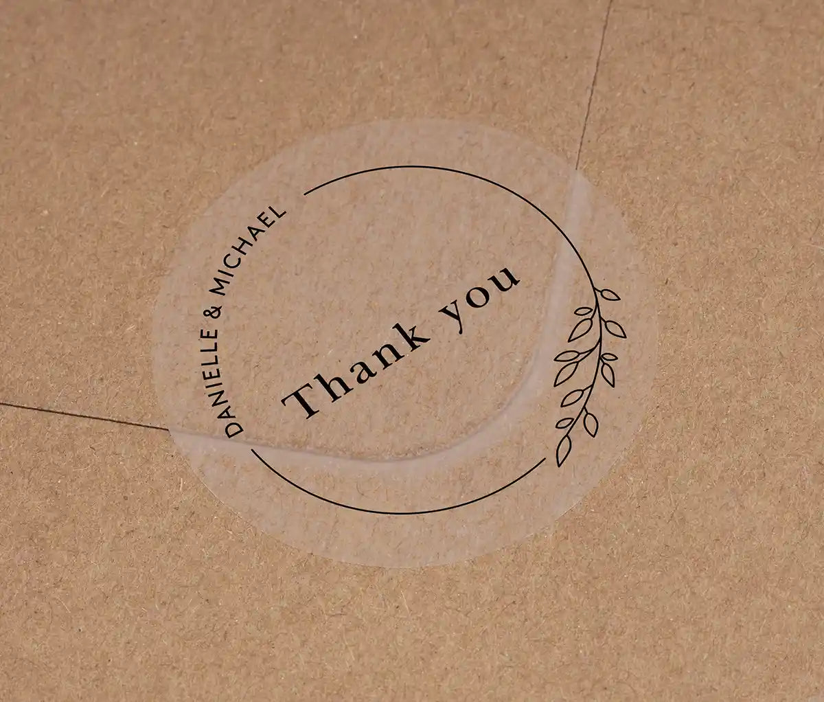 Wedding thank you sticker with personalized names and delicate floral theme frame printed in black on clear sticker