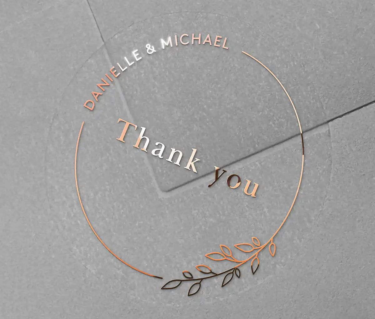 Wedding thank you sticker with personalized names and delicate floral theme frame printed in rose gold on clear sticker