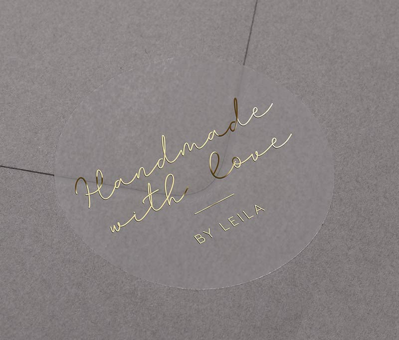 Handmade With Love sticker with personalized name printed in gold on round clear sticker
