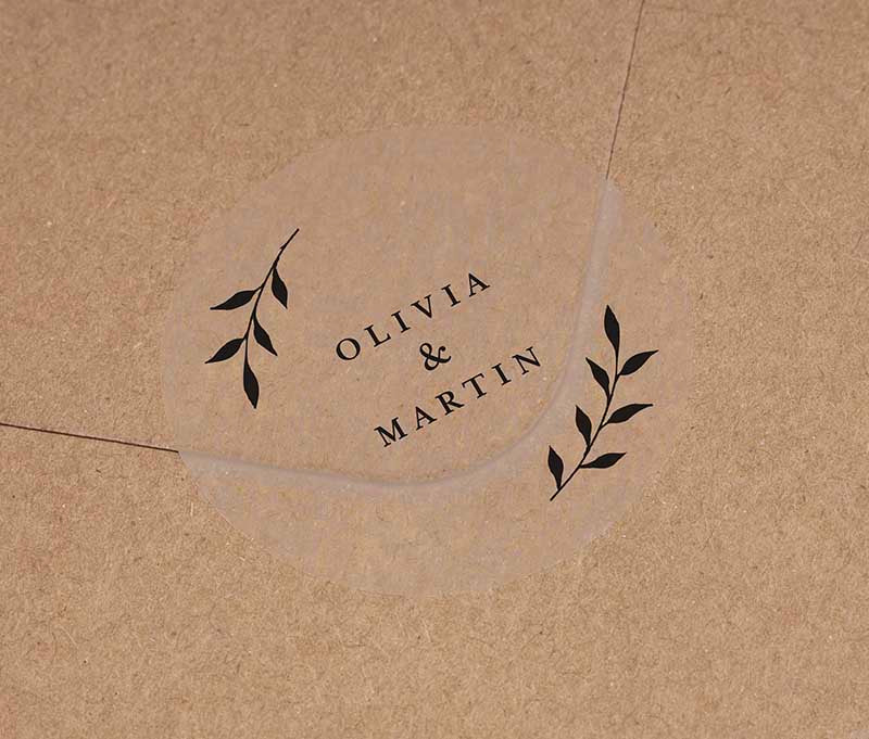 Wedding envelope seal with personalized names and laurel leaves graphic printed in black on round transparent frosted label