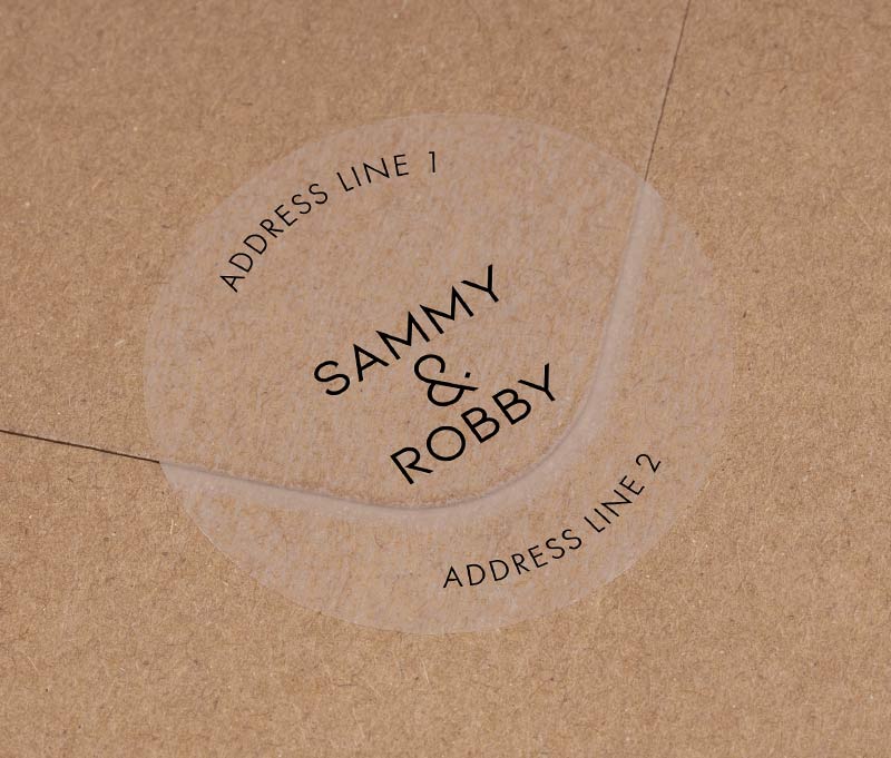 Return address labels with black printing on clear round labels, applied to an envelope.