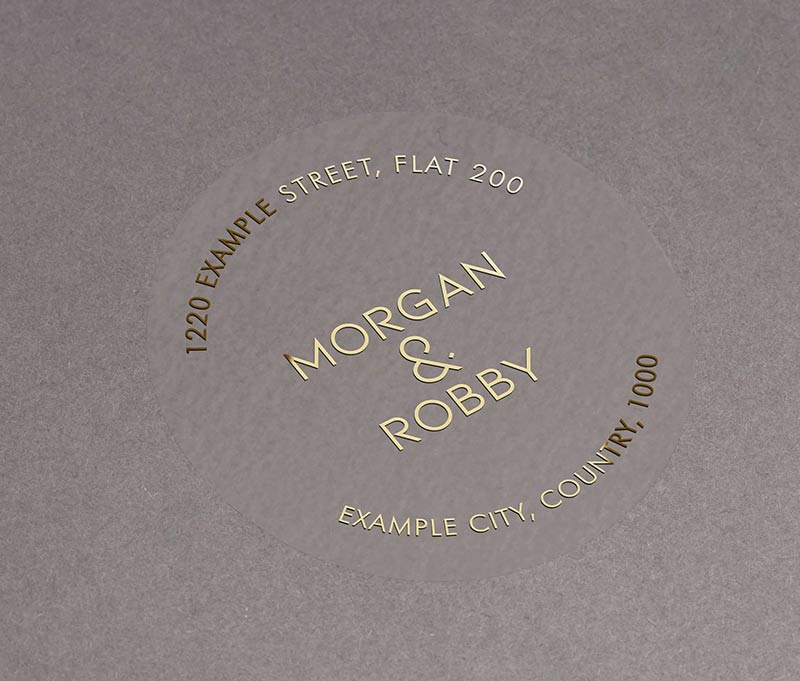 Return address labels with gold foil print on clear round labels