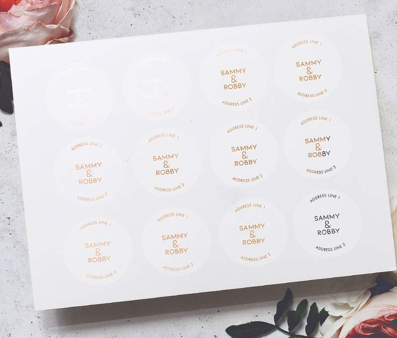 Return address labels sheet with rose gold foil printing on clear round labels.