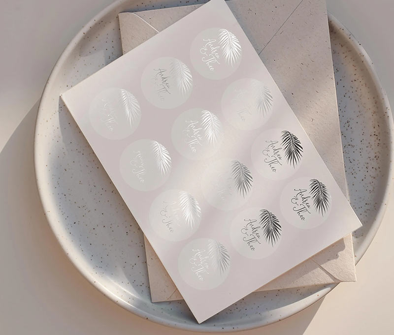 Wedding envelope sticker sheet with personalized names and palm image printed in silver on clear label