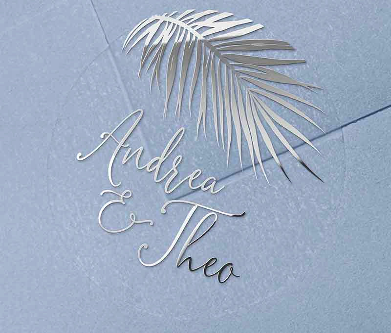 Tropical wedding envelope sticker with personalized names and palm leaf graphic printed in silver on round transparent frosted label