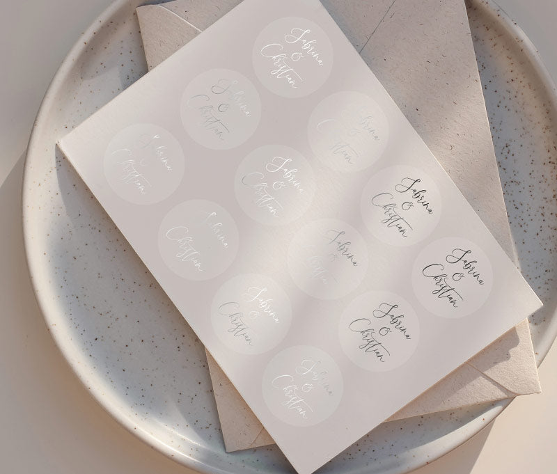 Wedding favor sticker sheet with personalized names printed in silver foil on clear round sticker
