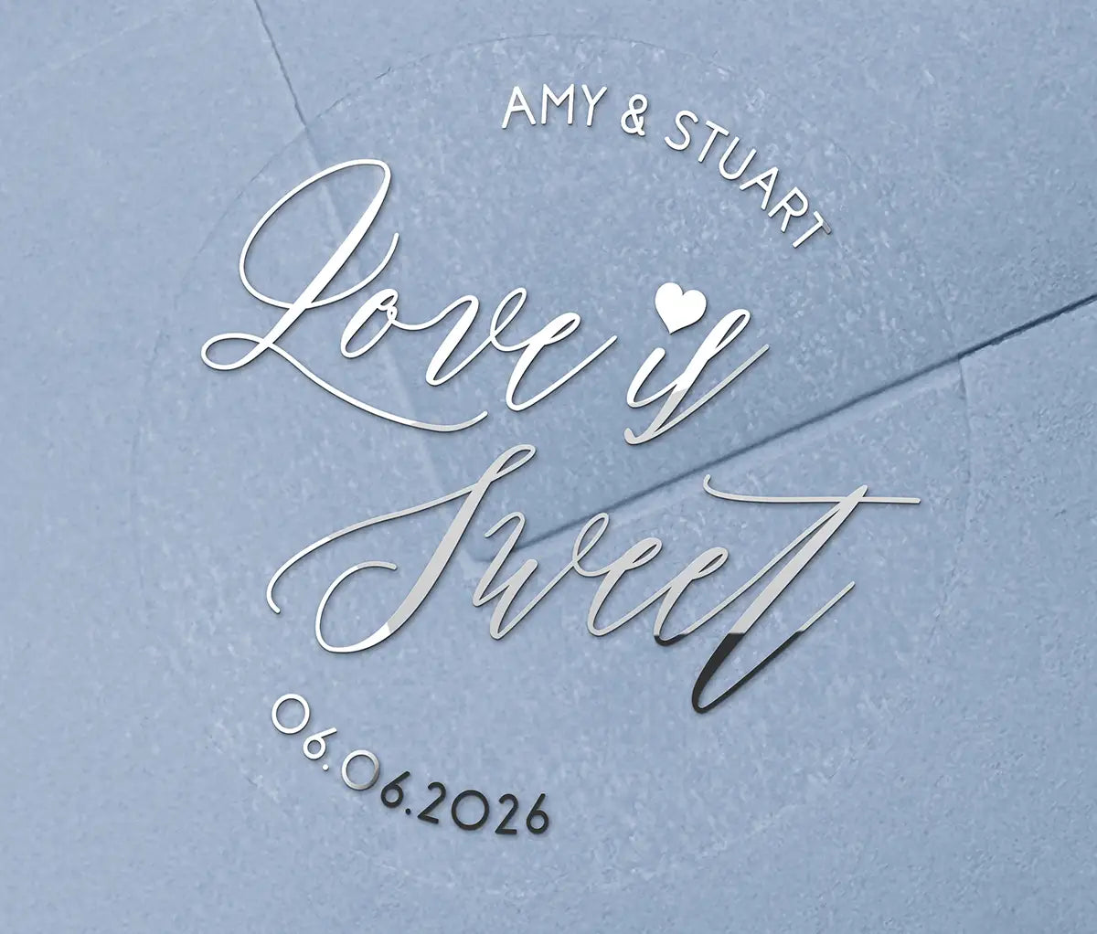 Love is sweet wedding favor sticker with heart graphic personalized names and date printed in silver on clear sticker