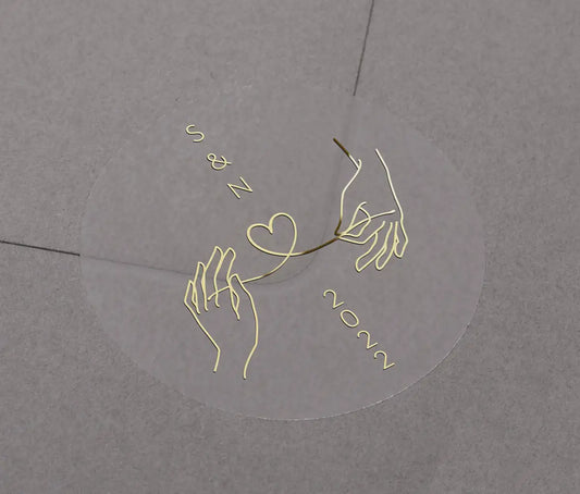 Wedding envelope sticker with personalised initials printed on clear sticker in gold foil