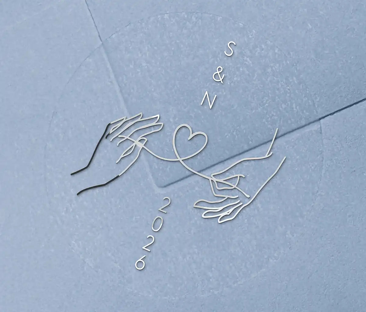 Wedding envelope seal with personalised initials printed on clear sticker in silver foil