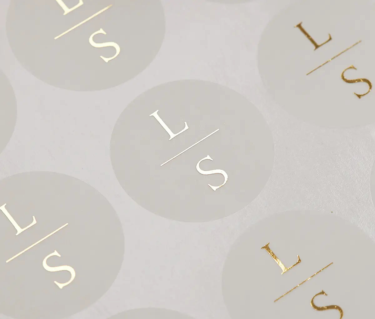 Personalized initials printed in gold foil on round clear sticker sheet