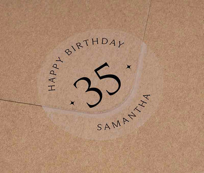 Personalized age and name birthday sticker printed in black ink on transparent frosted round sticker