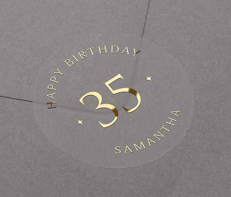 Personalized age and name birthday sticker printed in gold foil on transparent frosted round sticker