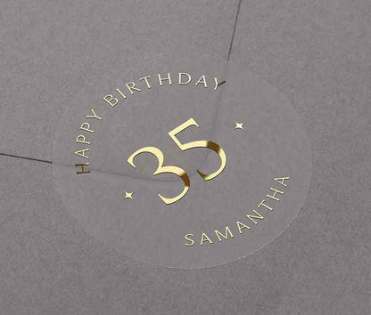 Personalized age and name birthday sticker printed in gold foil on transparent frosted round sticker
