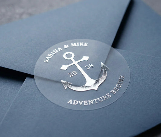 Personalized wedding sticker with anchor graphic printed in silver foil applied to a navy colour envelope.