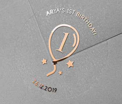 Birthday stickers with a balloon graphic and personalized name and date printed in rose gold on a clear sticker