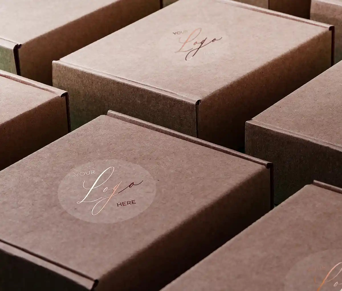 Rose gold foil printed custom business logo on clear round sticker applied on packaging boxes