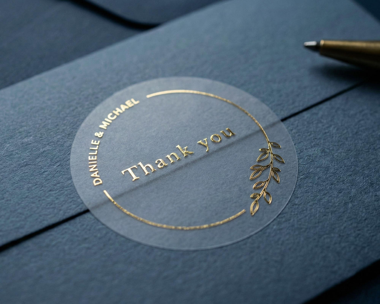 Wedding thank you sticker with personalized names and delicate floral theme frame printed in gold on clear sticker