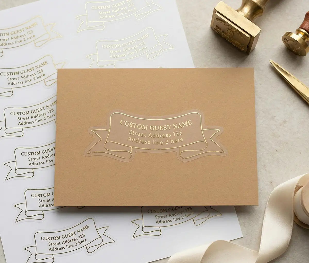 Wedding stationery photograph with Camel Colour Envelope and Ribbon Shape Recipient Label applied to it. The Sticker is printed with gold foil on transparent material.