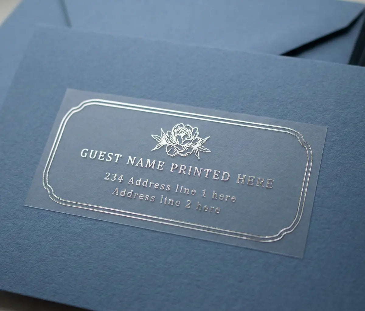 Blue card with a premium clear label printed in silver foil for guest name and address