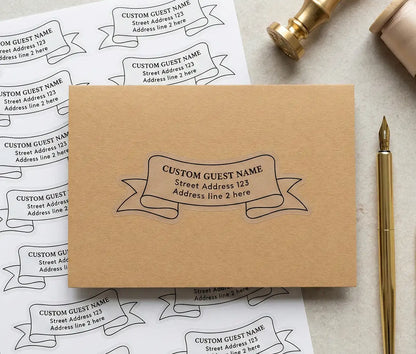 Black colour wedding guest address label custom die cut in ribbon shape applied to an envelope with sticker sheet in the background