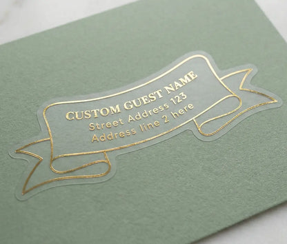 Clear guest address label printed in gold foil and custom die cut in ribbon shape