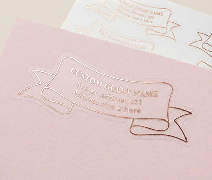 Unique shape recipient label custom cut and foiled in rose gold applied to a pink envelope