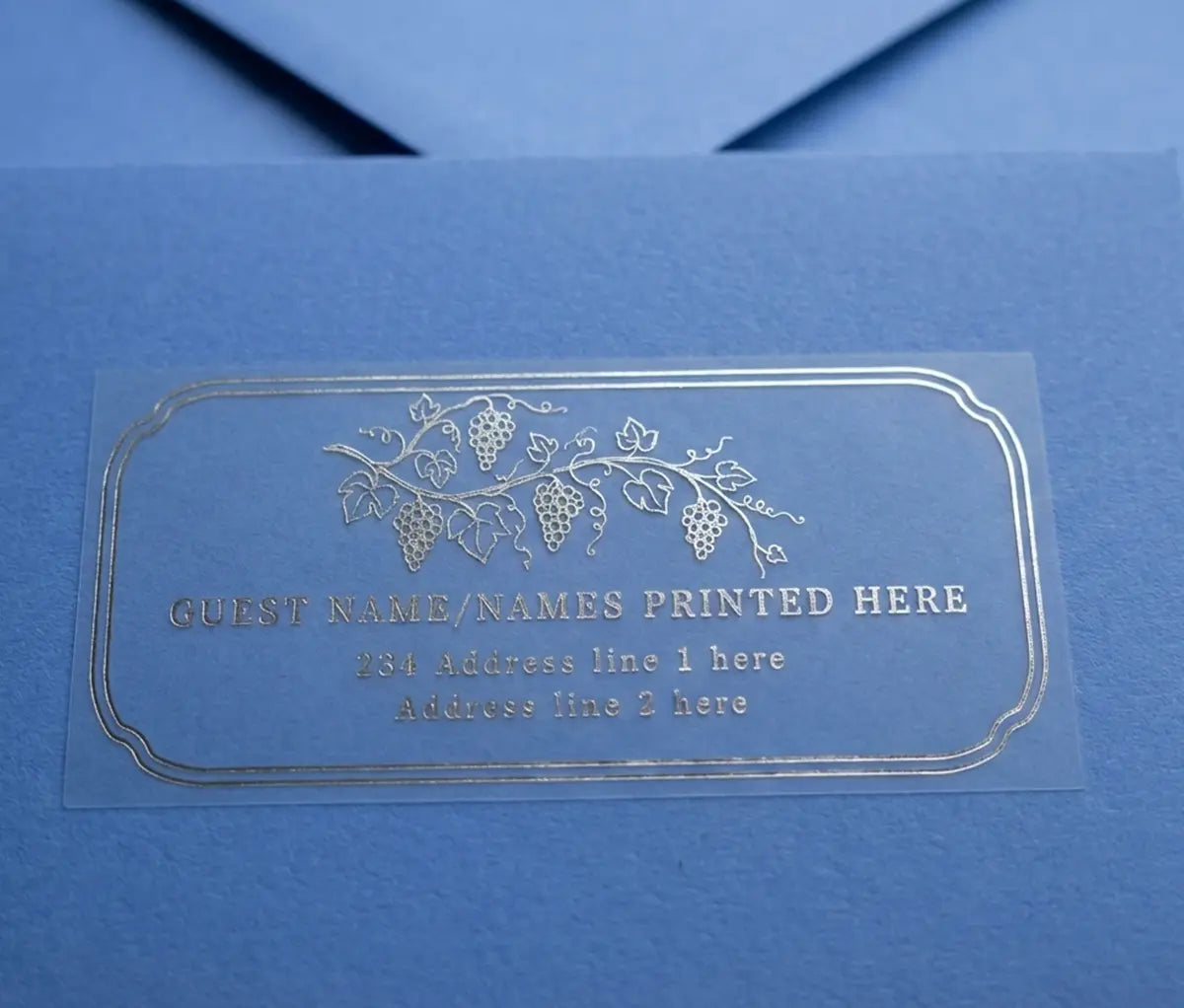 Vineyard inspired guest address label printed in silver foil on clear matte vinyl and applied to a blue envelope.