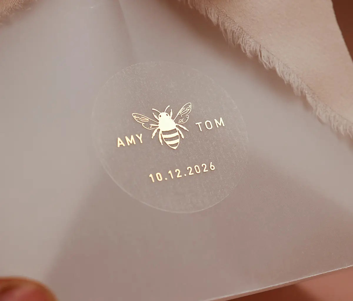 Honey bee graphic and personalized names printed on clear round sticker for wedding favors