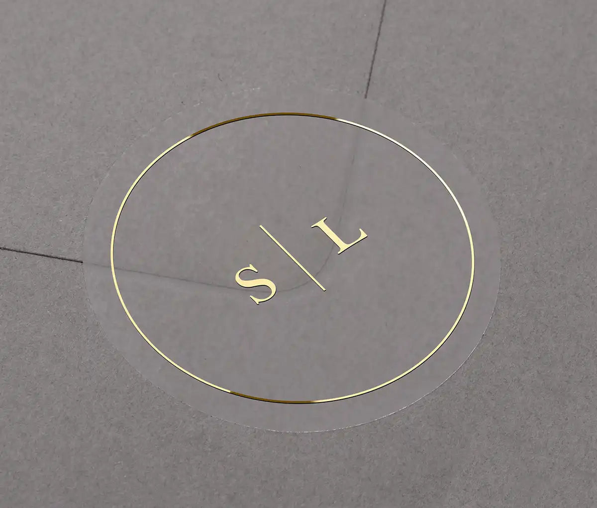 Minimalist Wedding envelope stickers with personalized initials printed in gold on clear round label