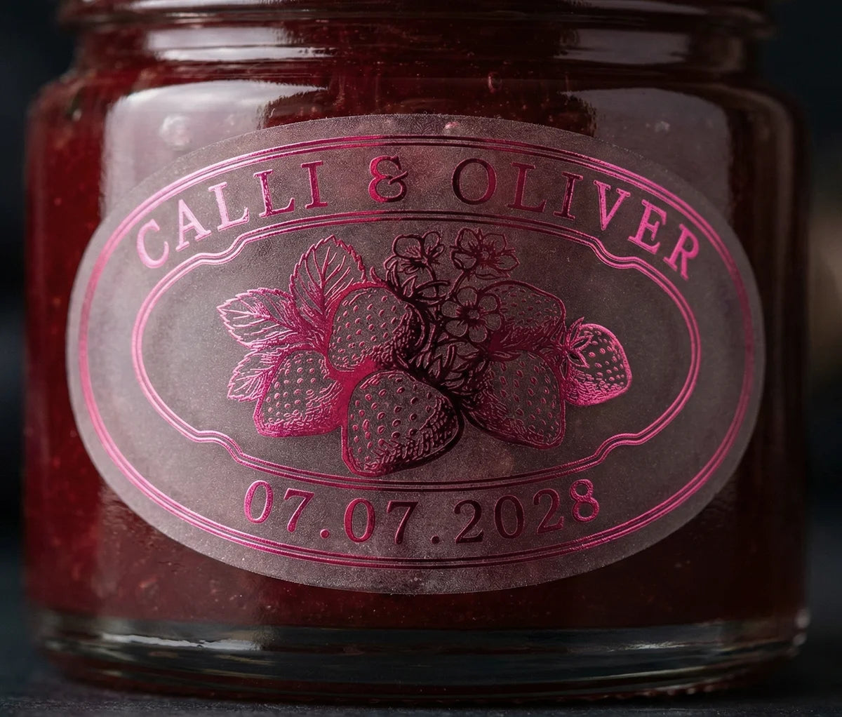 Jar of jam with personalized oval shape sticker printed in hot pink foil on transparent matte vinyl