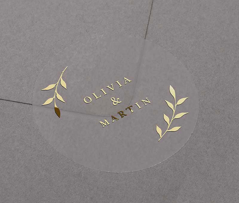 Gold foil wedding envelope seal with personalized names printed on round transparent frosted label