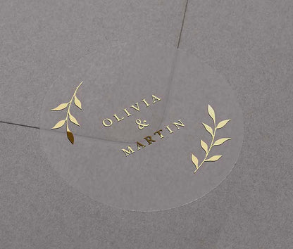 Gold foil wedding envelope seal with personalized names printed on round transparent frosted label