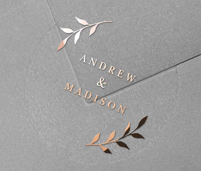Wedding envelope sticker with personalized names and laurel leaves graphic printed in rose gold on round transparent frosted label