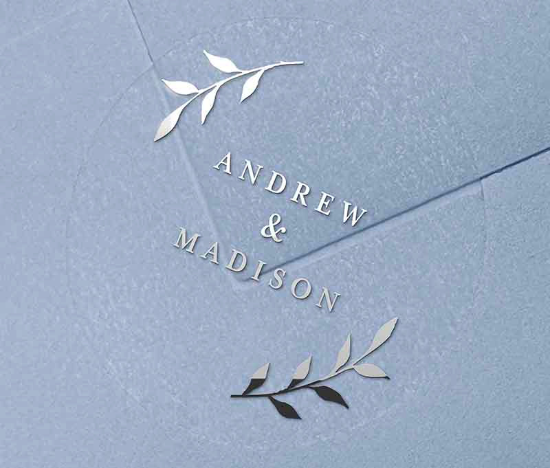 Silver foil wedding envelope label with personalized names and laurel leaves graphic printed on round transparent frosted label
