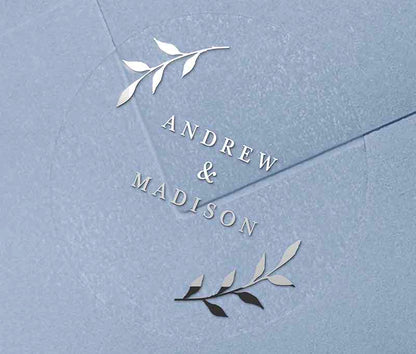Silver foil wedding envelope label with personalized names and laurel leaves graphic printed on round transparent frosted label