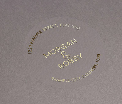 Return address labels with gold foil print on clear round labels
