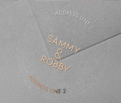 Return address labels with rose gold foil printing on clear round labels, applied to an envelope.