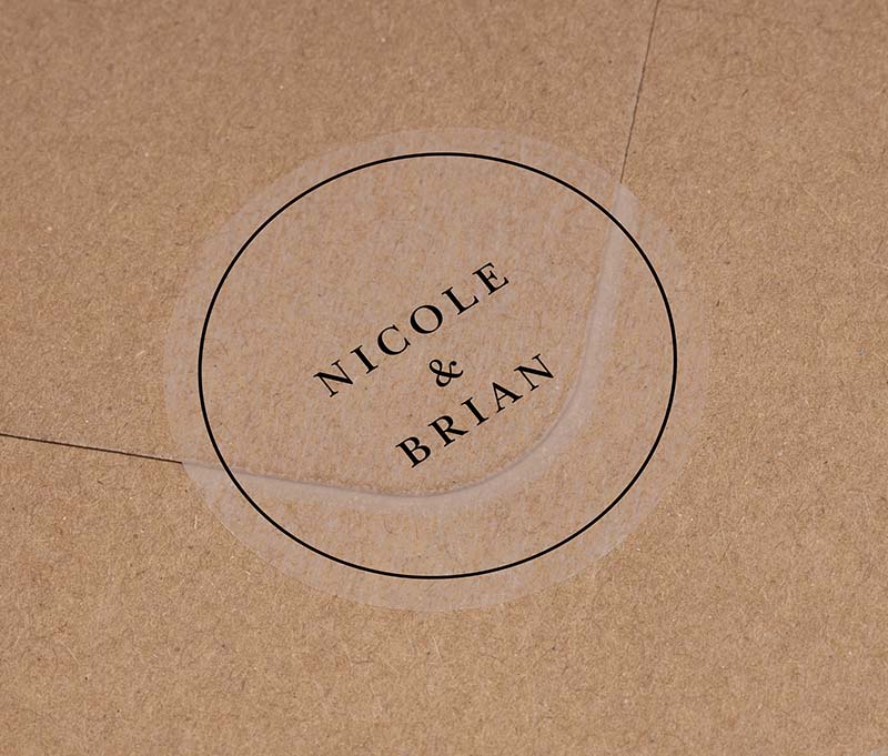 Wedding envelope ticker with personalized names printed in black ink on round transparent frosted label