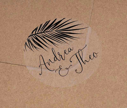 Tropical wedding envelope sticker with personalized names and palm leaf graphic printed in black on round transparent frosted label