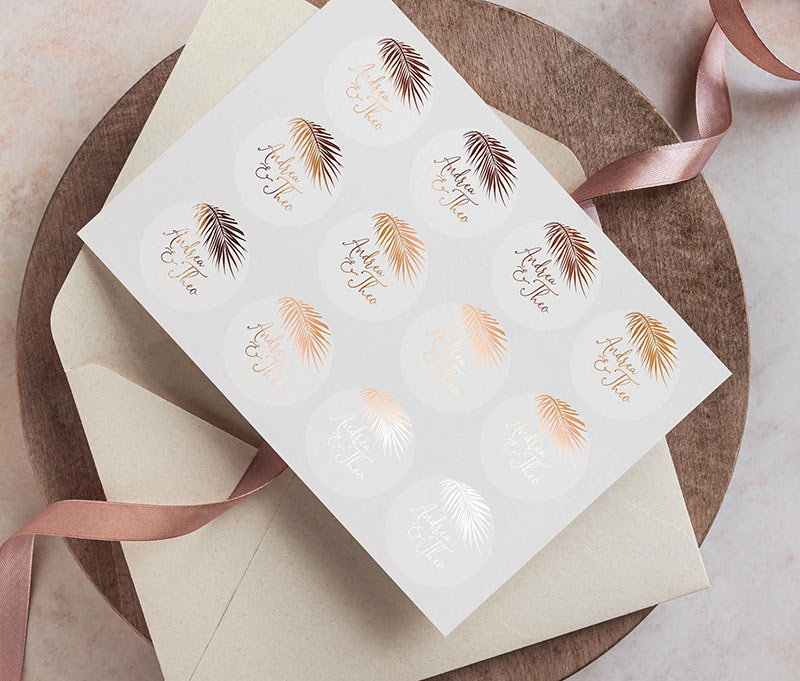 Wedding envelope sticker sheet with personalized names and palm image printed in rose gold on clear label