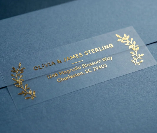 Return Address Label with Laurel Leaf Motif printed in gold foil on transparent matte labels applied to a blue envelope.