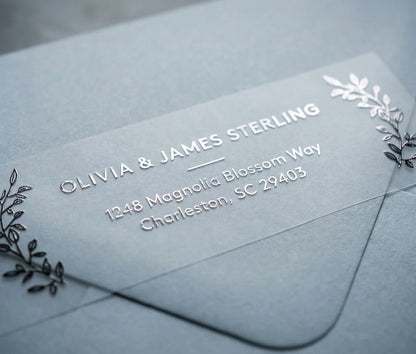 Return Address Label with Olive Leaf Motif printed in silver foil on transparent matte labels applied to a grey envelope.