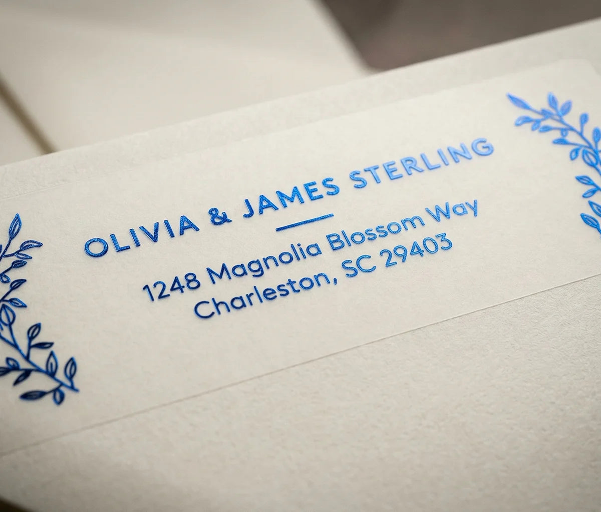 Return Address Label with Mediterranean Botanical Motif printed in Royal Blue foil on transparent matte labels applied to a ivory envelope.