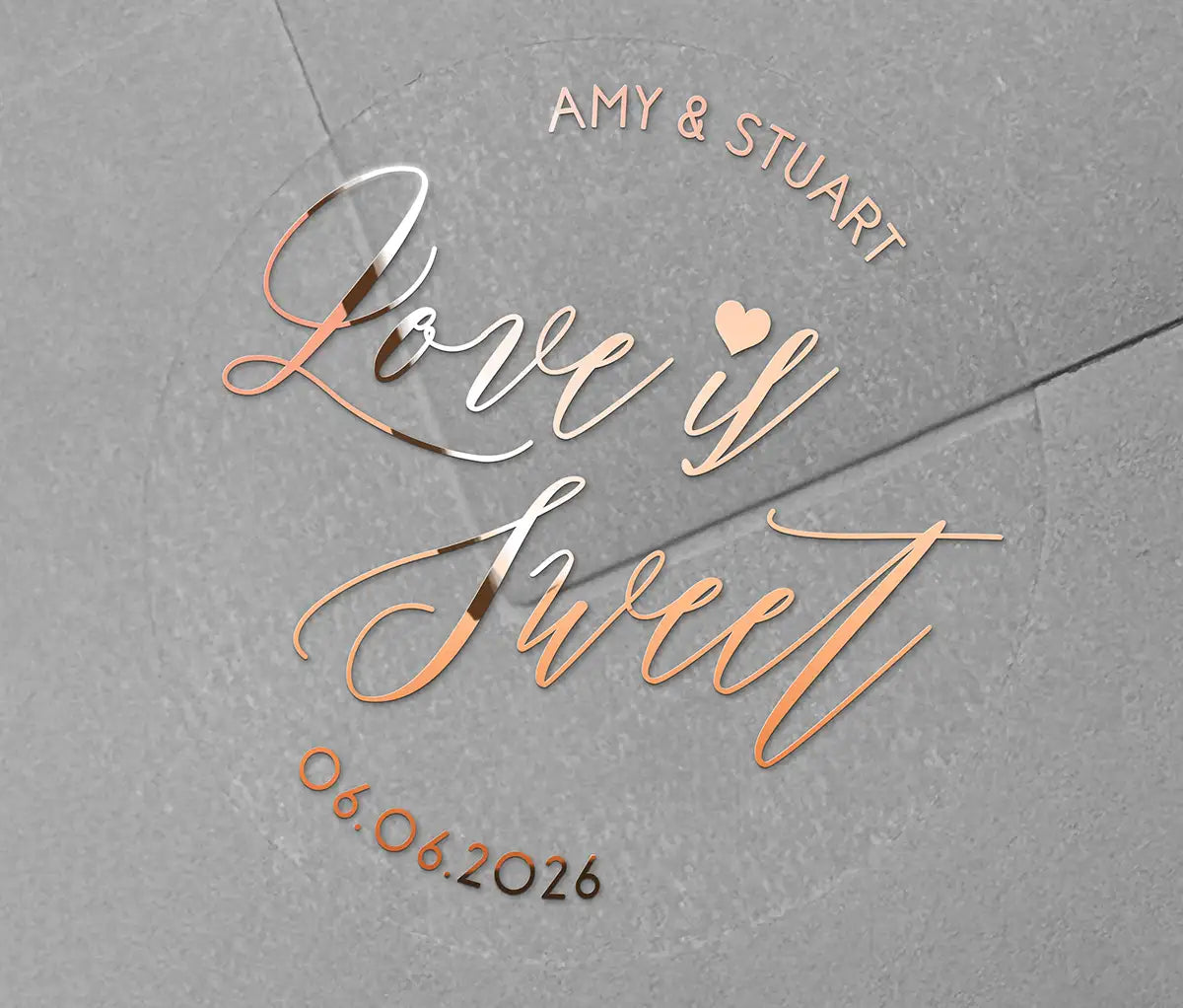 Love is sweet wedding favor sticker with heart graphic personalized names and date printed in rose gold on clear sticker