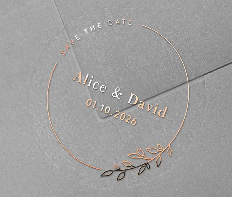 Save The Date sticker with personalised names and date and thin frame with leaves printed in rose gold on clear round label
