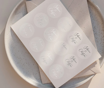 Wedding favor sticker sheet with personalized names printed in silver foil on clear round sticker