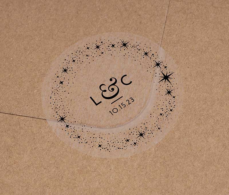 Celestial wedding favor stickers with stars around personalized initials and date printed in black on clear sticker