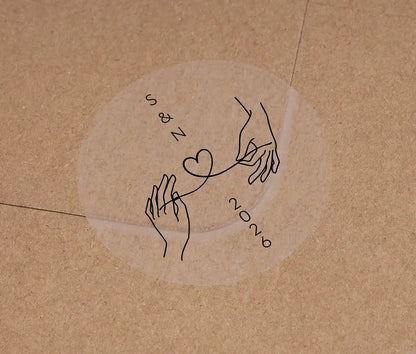 Wedding envelope sticker with personalised initials printed on clear sticker in black ink